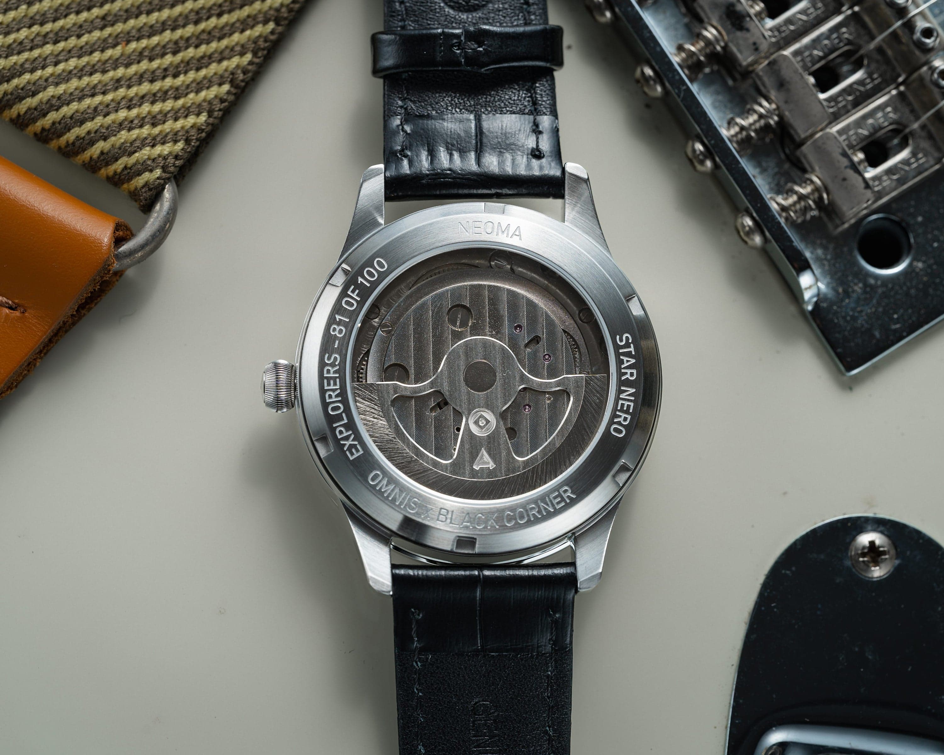 Neoma Star Nero by Black Corner × Omnis — steel caseback engraved "NEOMA / STAR NERO / EXPLORERS 81 OF 100 / OMNIS x BLACK CORNER", movement visible through the back