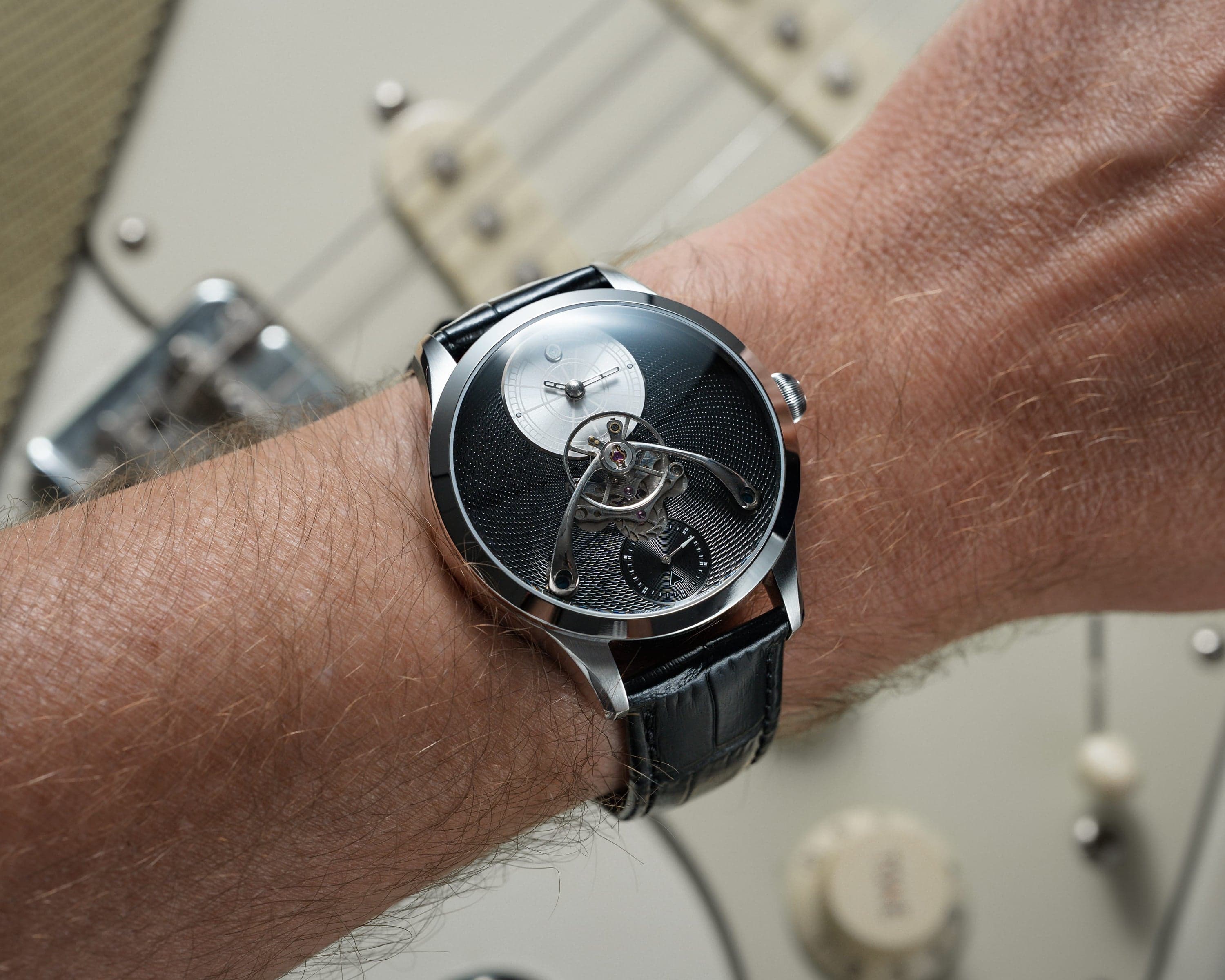 Neoma Star Nero by Black Corner × Omnis worn on the wrist, black guilloché dial and central balance bridge in view